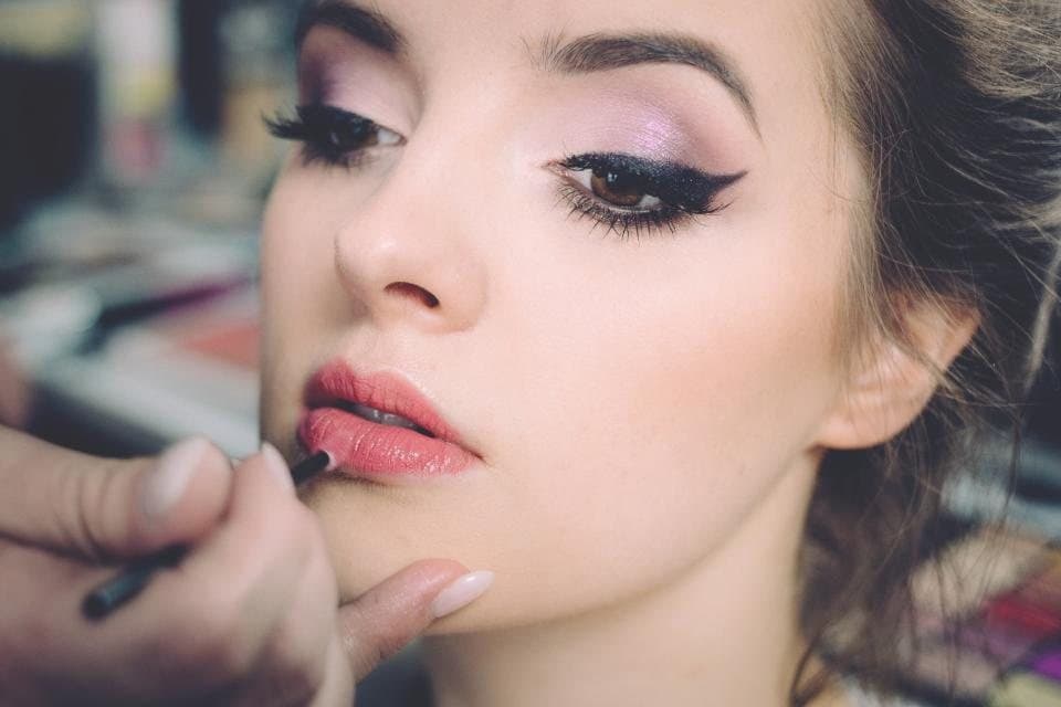 Eyeliner and lip makeup being applied